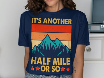 T-shirt with retro mountain graphic and text "IT'S ANOTHER HALF MILE OR SO".