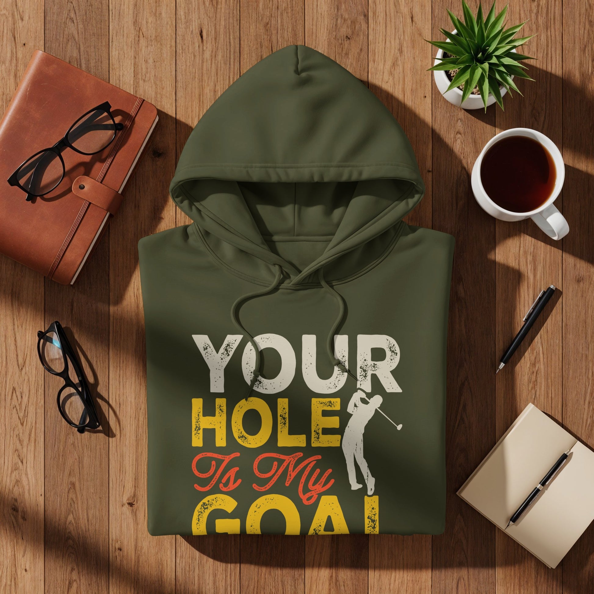 Olive green hoodie with "Your Hole Is My Goal" text and golfer graphic.