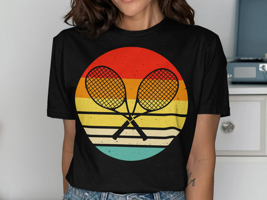 Crossed tennis rackets inside a colorful retro sunset circle graphic.