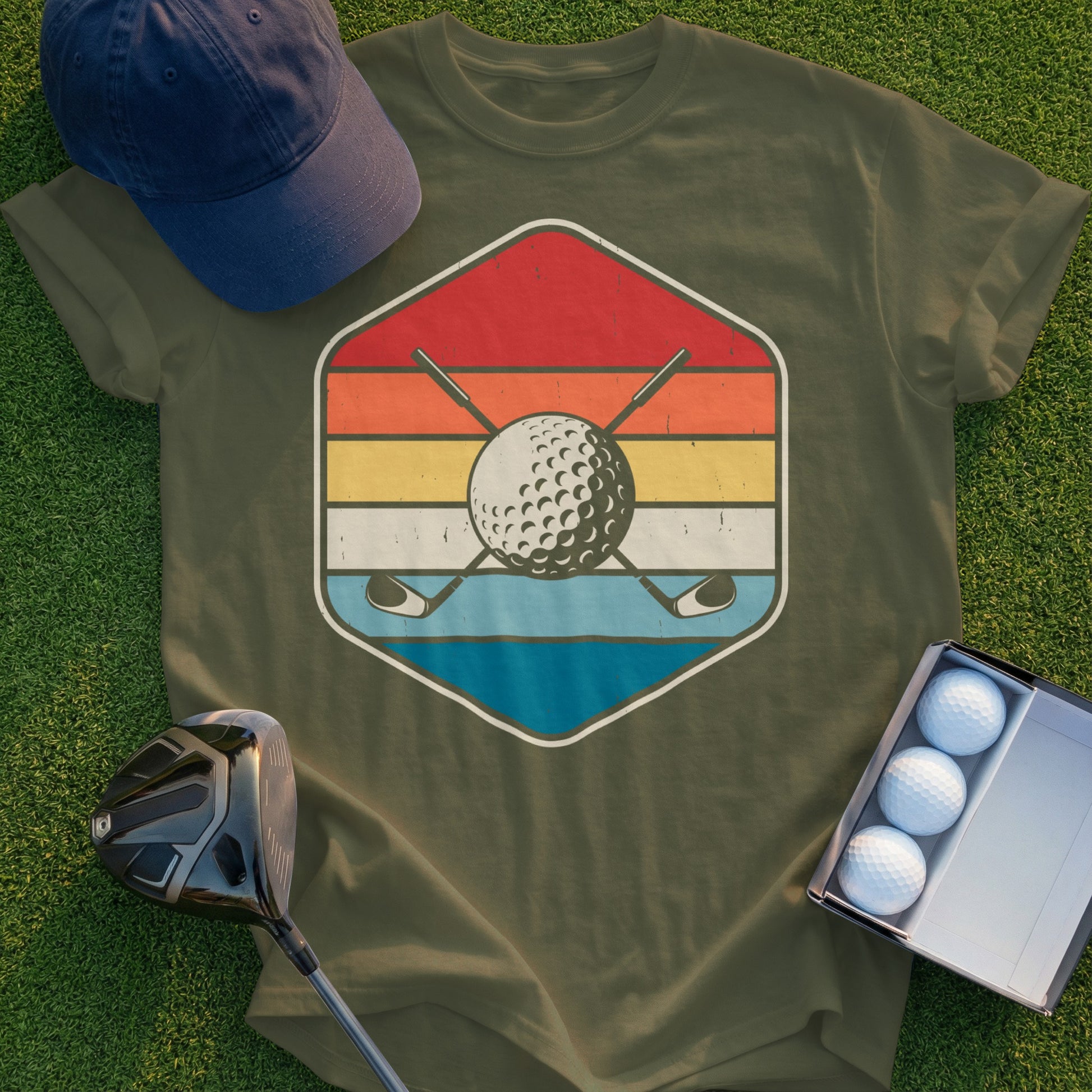 Golf ball and crossed clubs inside a retro hexagon on a green t-shirt.
