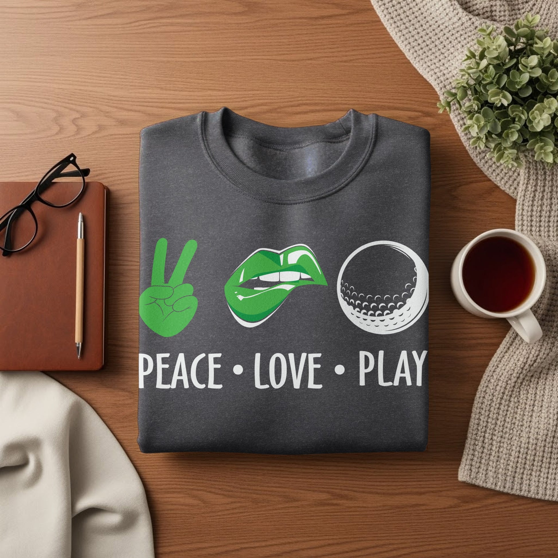 Dark gray sweatshirt with "Peace Love Play" text and golf icons.