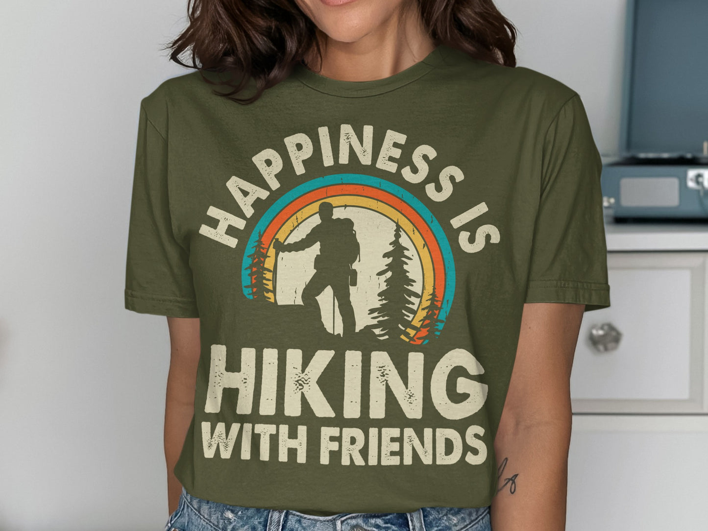 Olive t-shirt with "Happiness is Hiking with Friends" and rainbow mountain graphic.