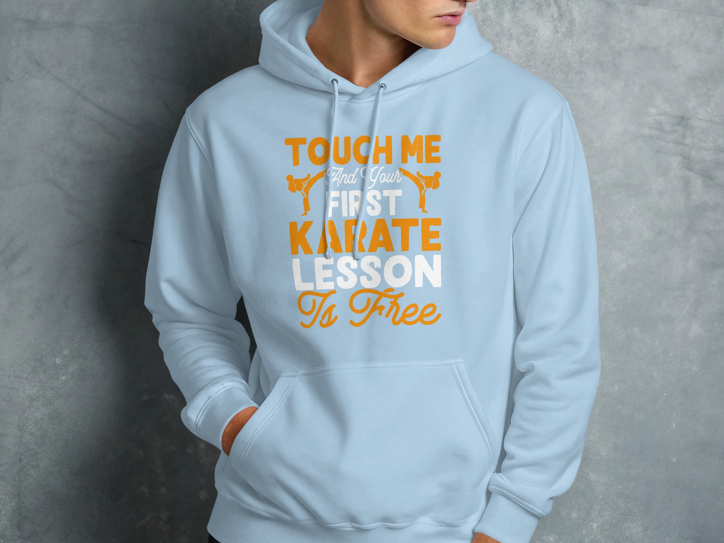 Light blue hoodie with orange text: "Touch Me and Your First Karate Lesson Is Free".
