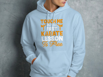 Light blue hoodie with orange text: "Touch Me and Your First Karate Lesson Is Free".