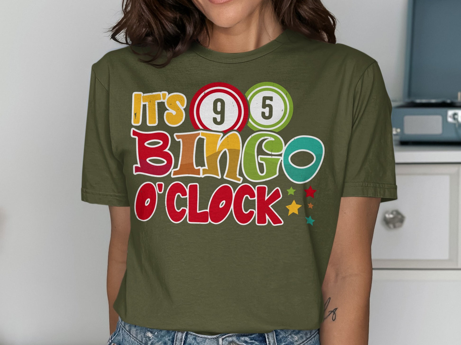 "It's Bingo O'Clock" text on a green t-shirt with colorful bingo balls.