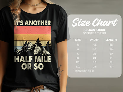 T-shirt with "IT'S ANOTHER HALF MILE OR SO" text and mountains.