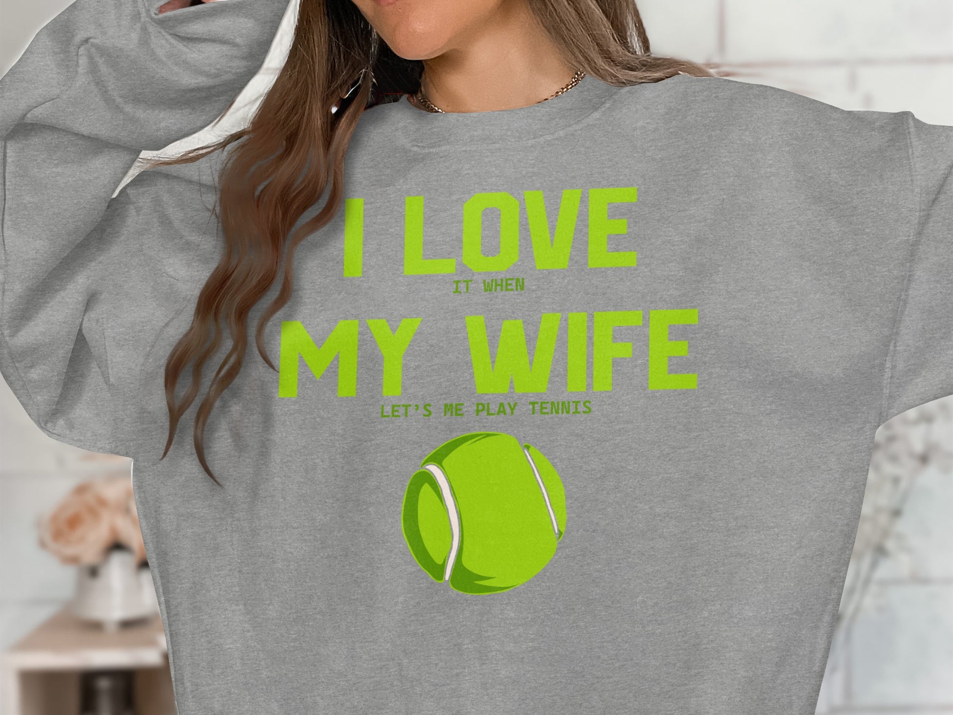 Gray sweatshirt with "I LOVE MY WIFE" text and tennis ball graphic.