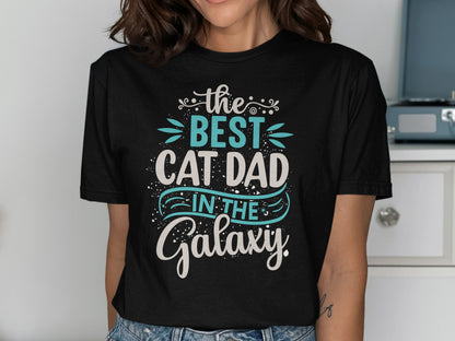 Black t-shirt with "The Best Cat Dad in the Galaxy" text.