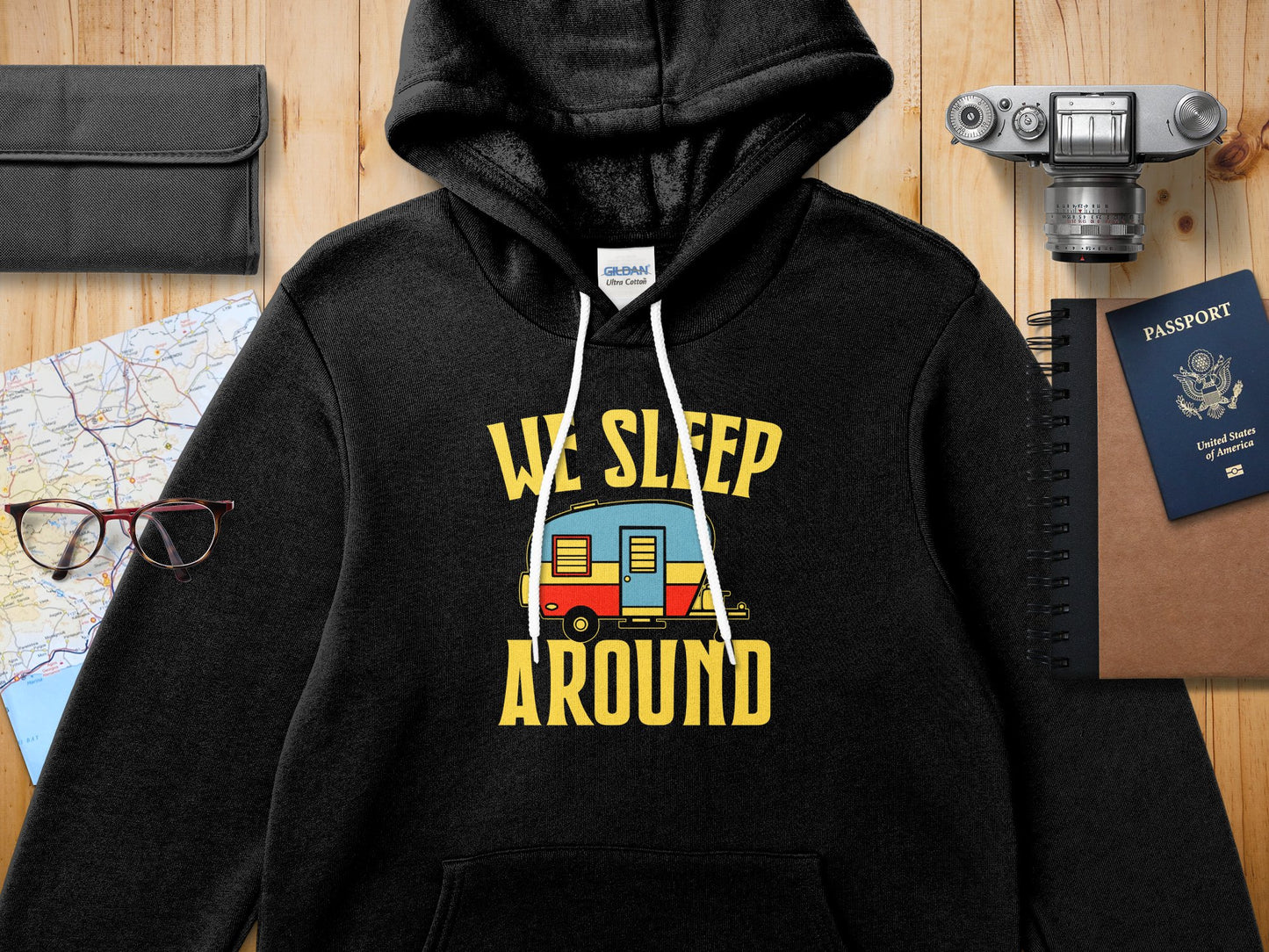 Black Gildan Ultra Cotton hoodie with "WE SLEEP AROUND" text and a caravan graphic.