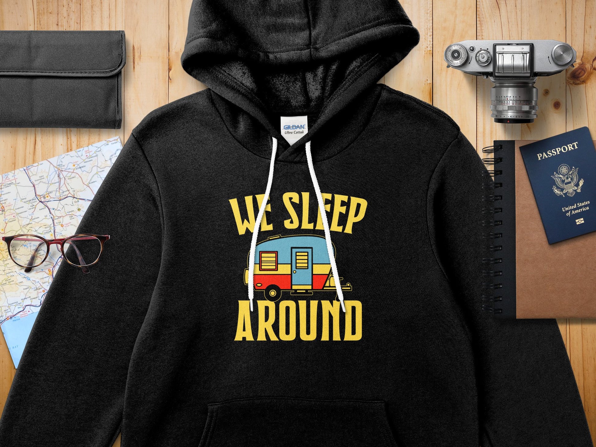 Black Gildan Ultra Cotton hoodie with "WE SLEEP AROUND" text and a caravan graphic.