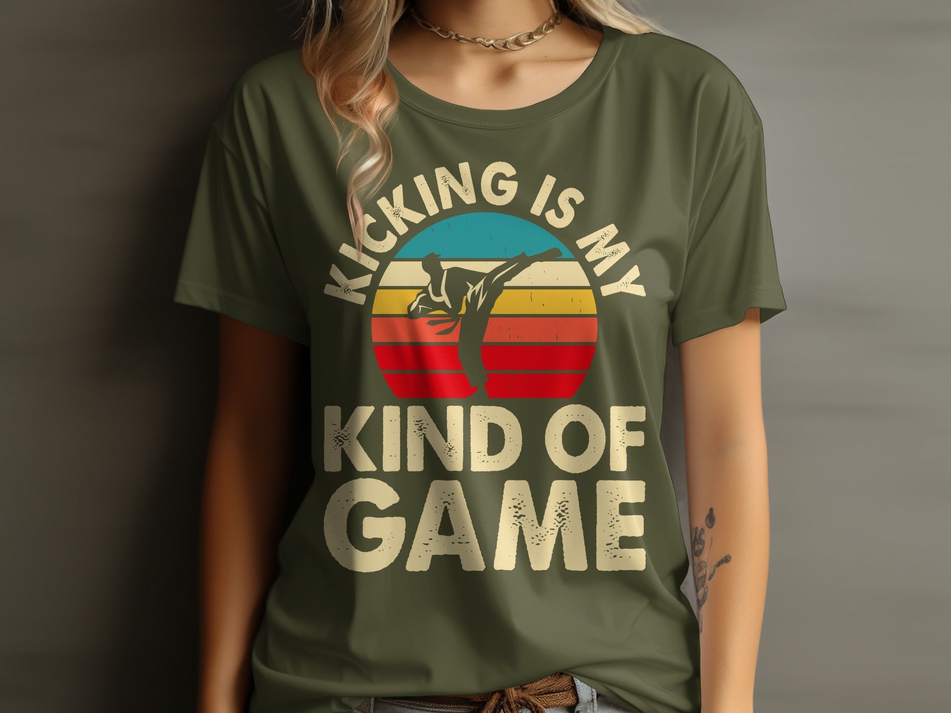 Olive green t-shirt with "Kicking is my game" and a sunset martial arts graphic.