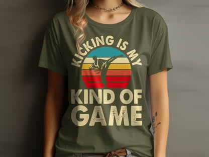 Olive green t-shirt with "Kicking is my game" and a sunset martial arts graphic.