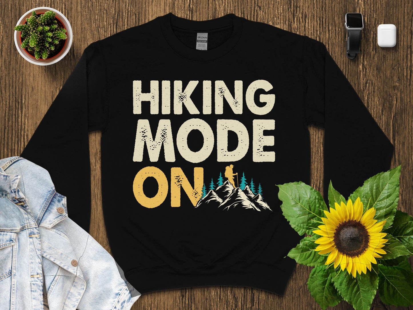 Black crewneck sweatshirt with "HIKING MODE ON" text and mountain graphic.
