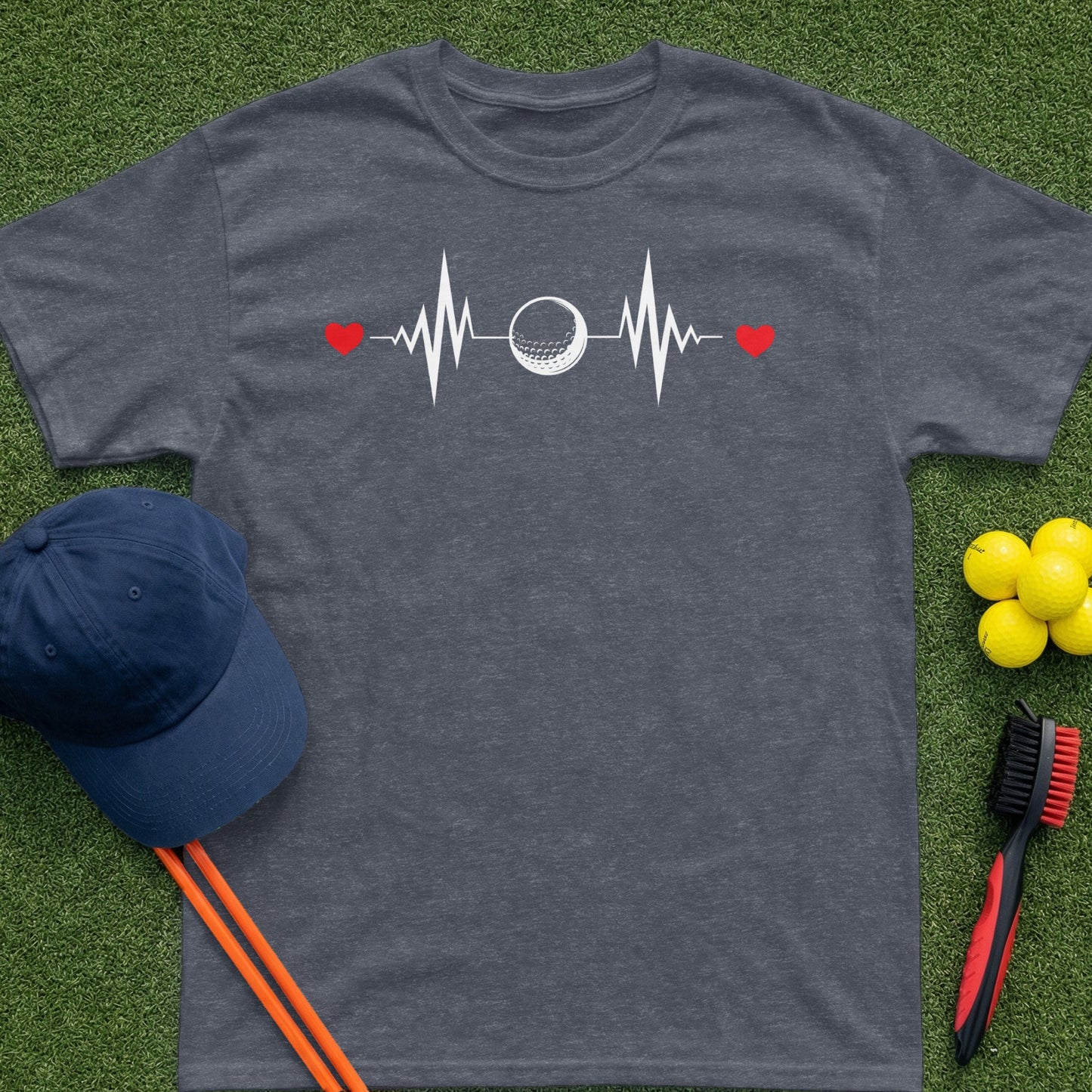 Dark grey t-shirt with a golf ball heartbeat graphic, red hearts, and golf accessories.