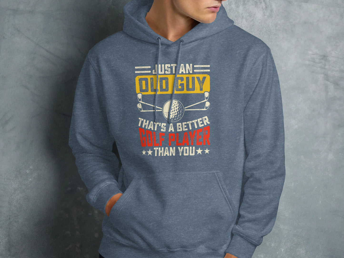 Gray hoodie with text "JUST AN OLD GUY THAT'S A BETTER GOLF PLAYER THAN YOU" and golf balls.