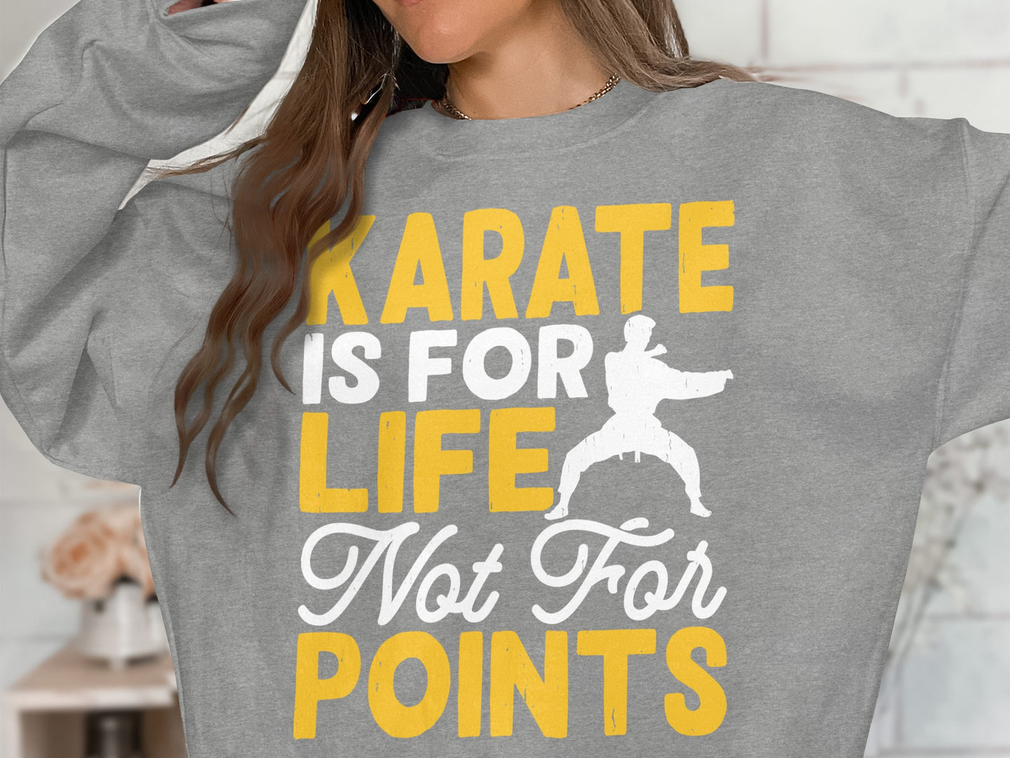 Grey sweatshirt with "Karate is for life, not for points" text and karate graphic.
