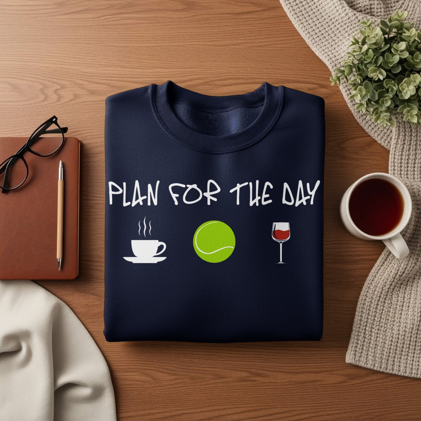 Navy sweatshirt with "PLAN FOR THE DAY" text, coffee, tennis, and wine icons.