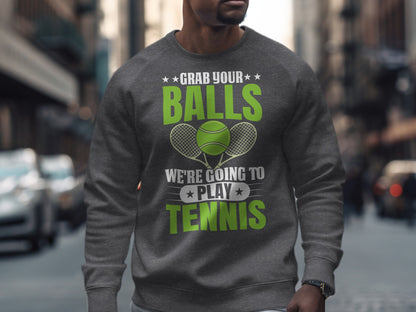Men's grey sweatshirt with "Grab Your Balls We're Going To Play Tennis" text and tennis rackets.