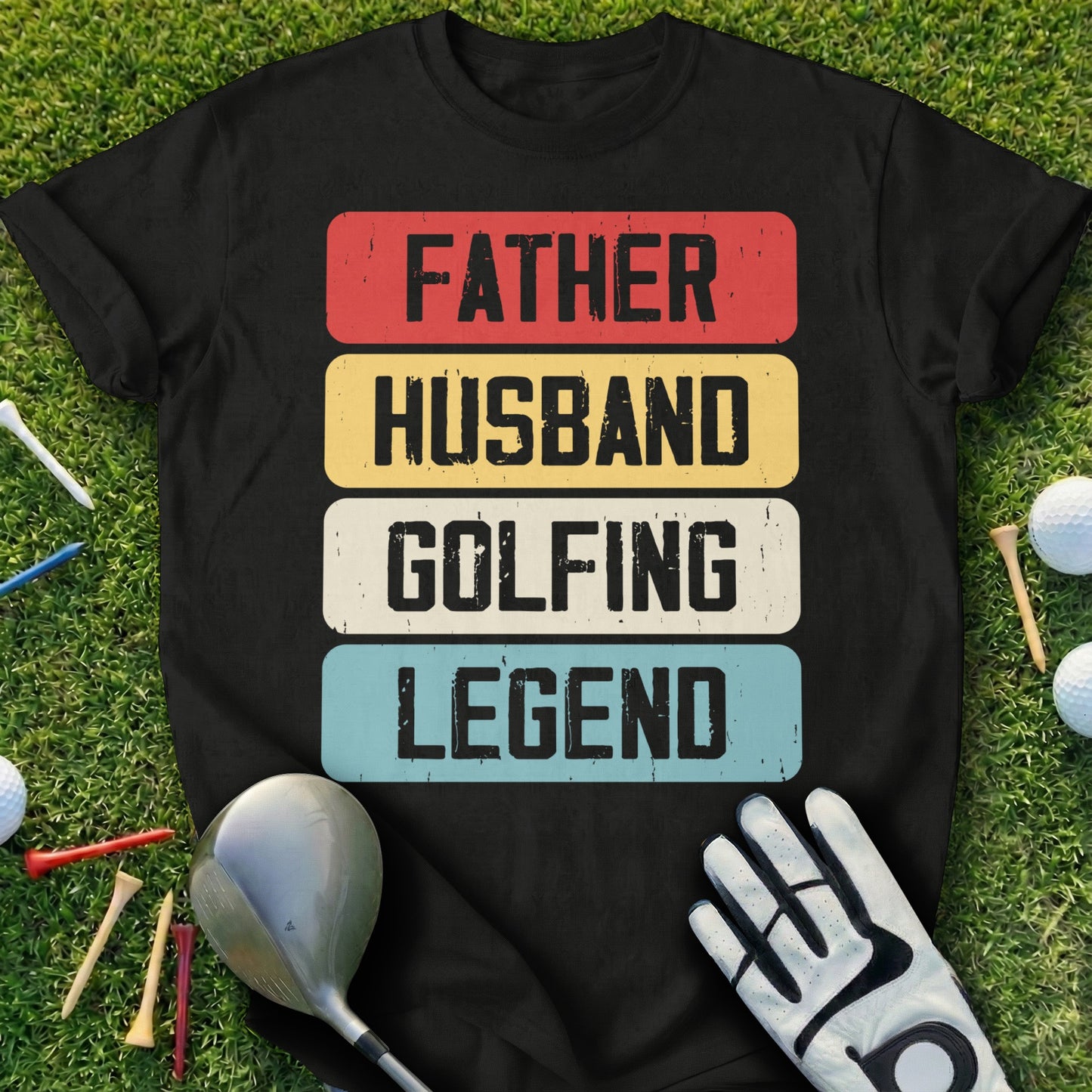Black t-shirt with "FATHER HUSBAND GOLFING LEGEND" text on a golf course.
