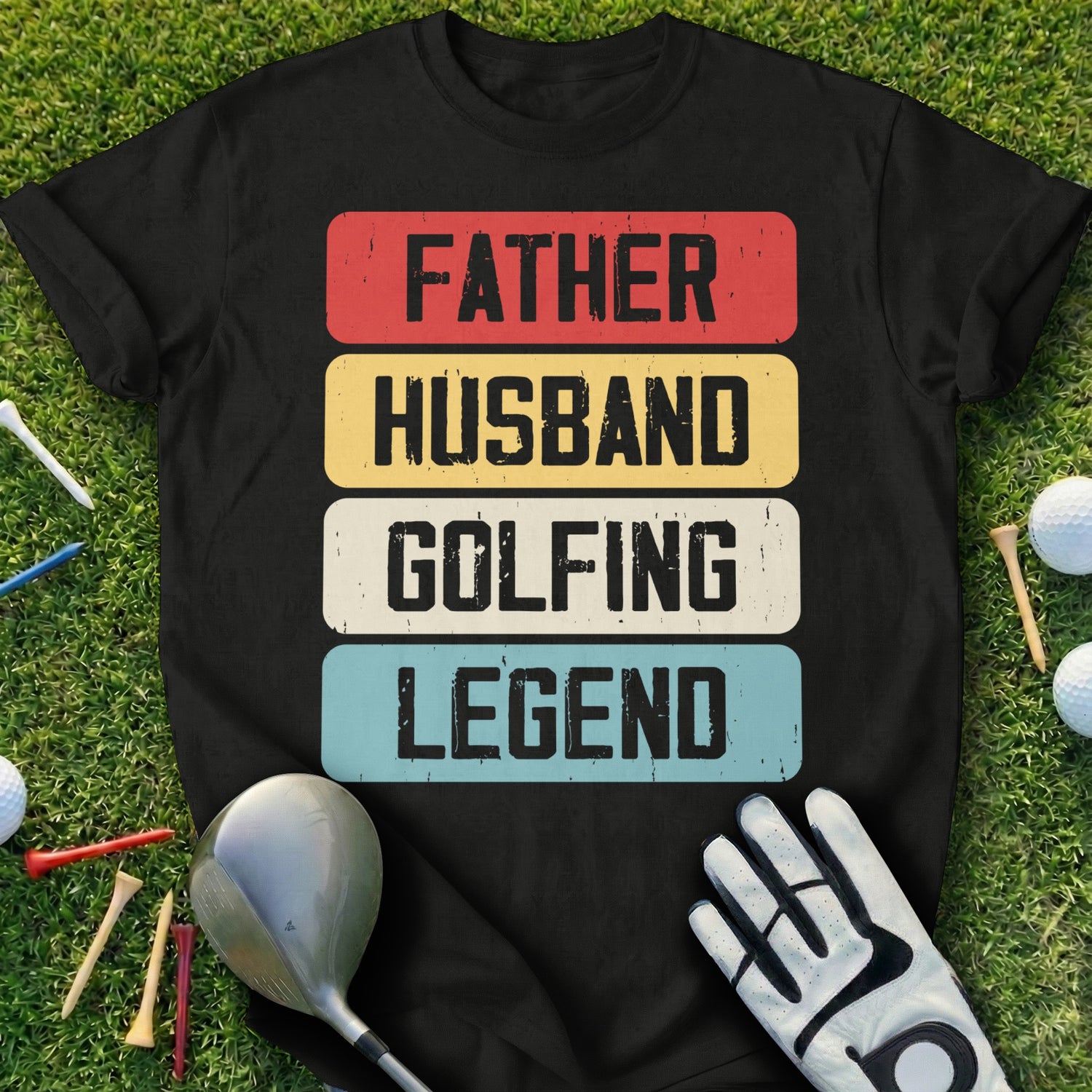 Black t-shirt with "FATHER HUSBAND GOLFING LEGEND" text on a golf course.
