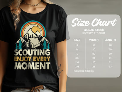 T-shirt with "Scouting Enjoy Every Moment" text, mountains, and tent graphic; includes size chart.