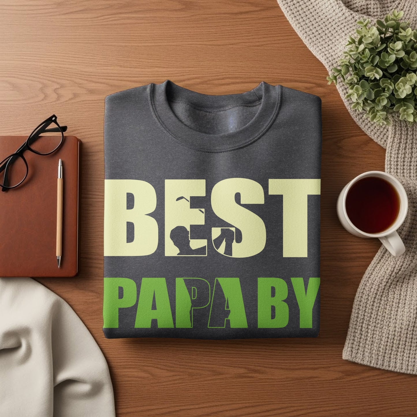 Dark gray sweatshirt with "BEST PAPA BY" text in beige and green.