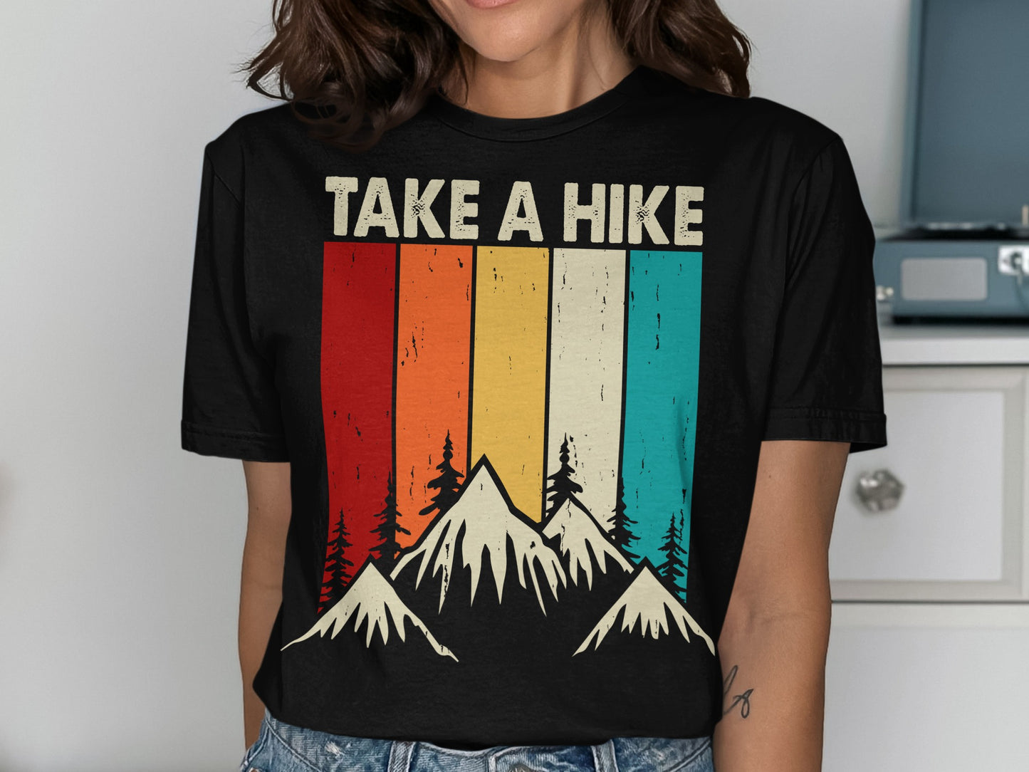 Black t-shirt with "TAKE A HIKE" text and mountain landscape design.