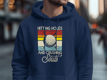 Navy hoodie with golf graphic and text "Hitting holes and crushing souls".