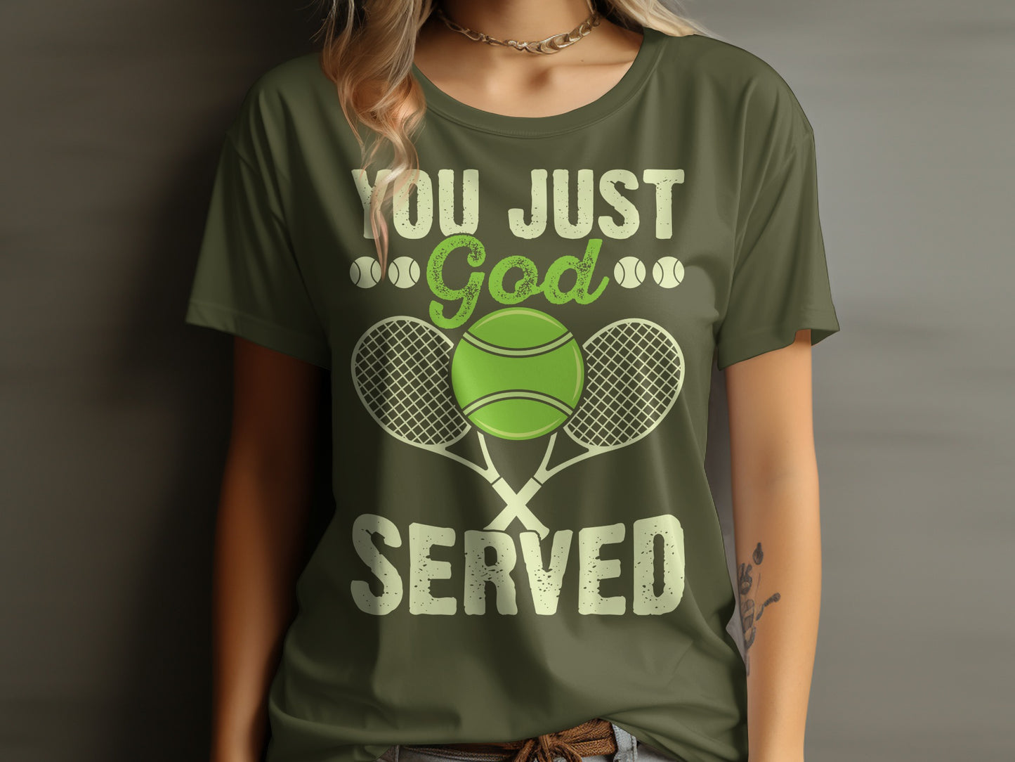 Olive green t-shirt with "You Just God Served" and tennis graphics.