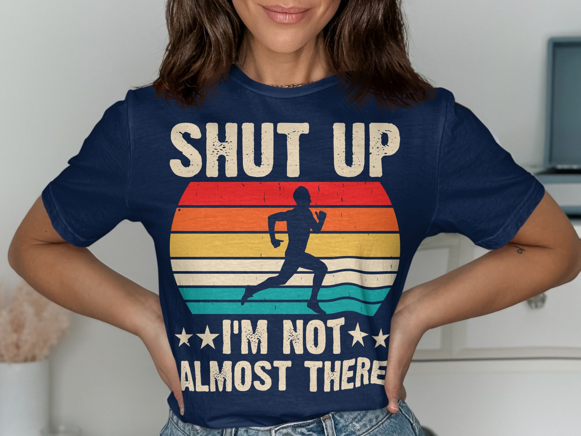 Navy t-shirt with runner graphic and "SHUT UP I'M NOT ALMOST THERE" text.