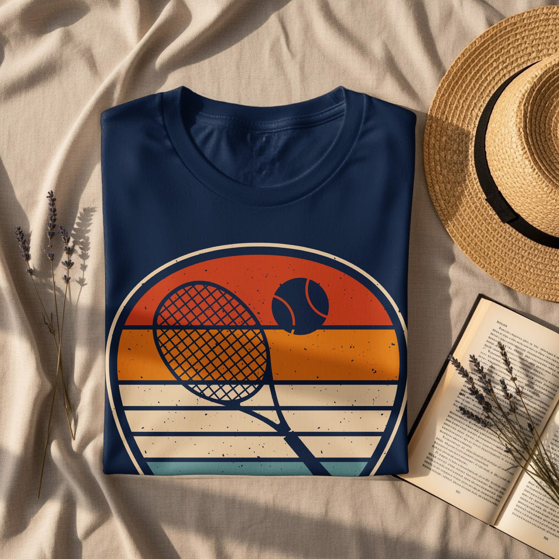 Navy t-shirt with vintage tennis racket and ball graphic and straw hat.