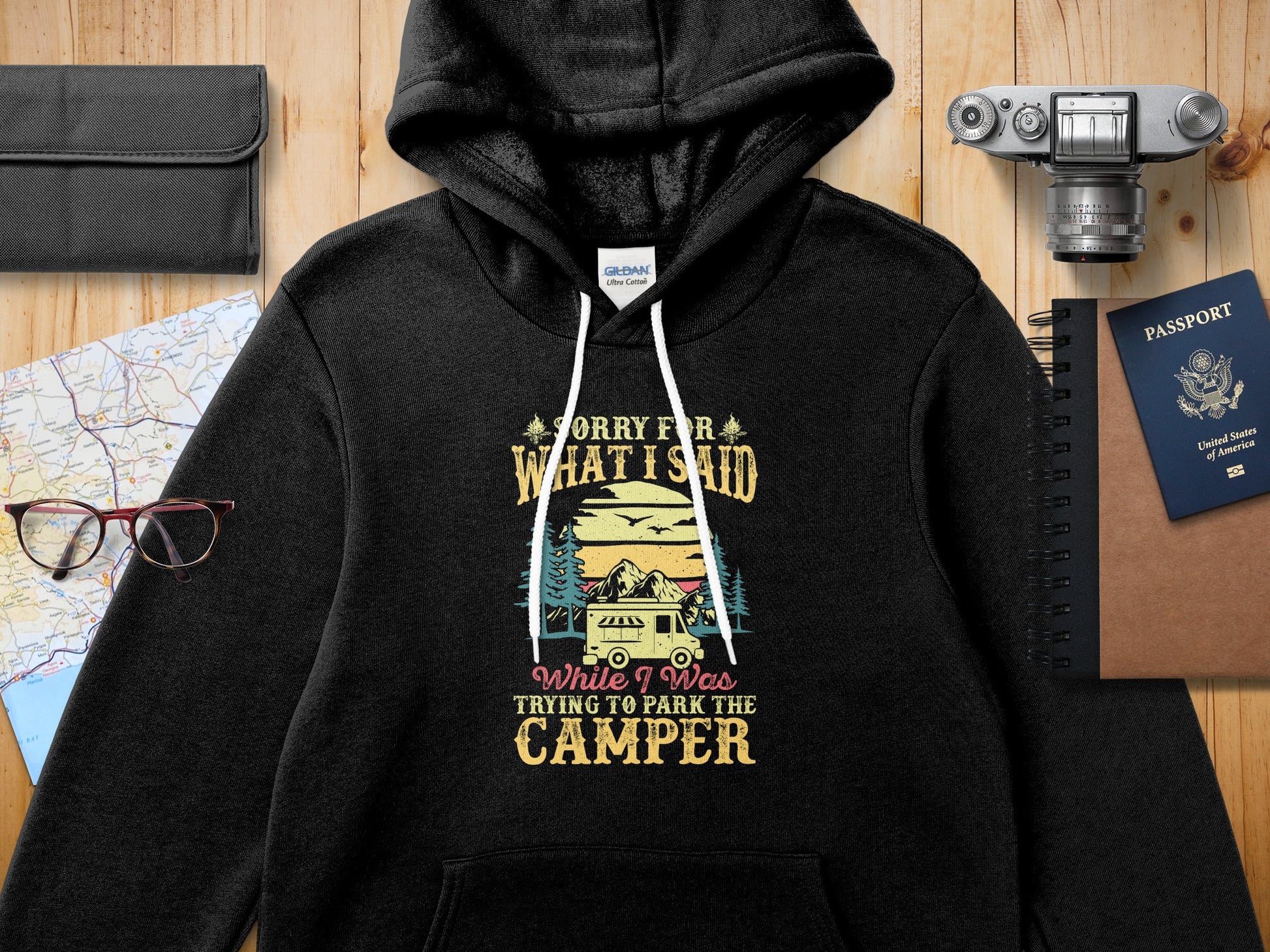Black hoodie with "Sorry for what I said while I was trying to park the camper" text and graphic.