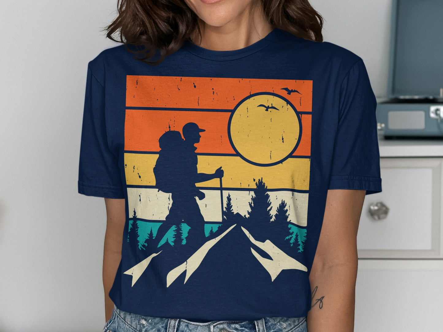 Retro sunset hiking graphic on navy t-shirt.