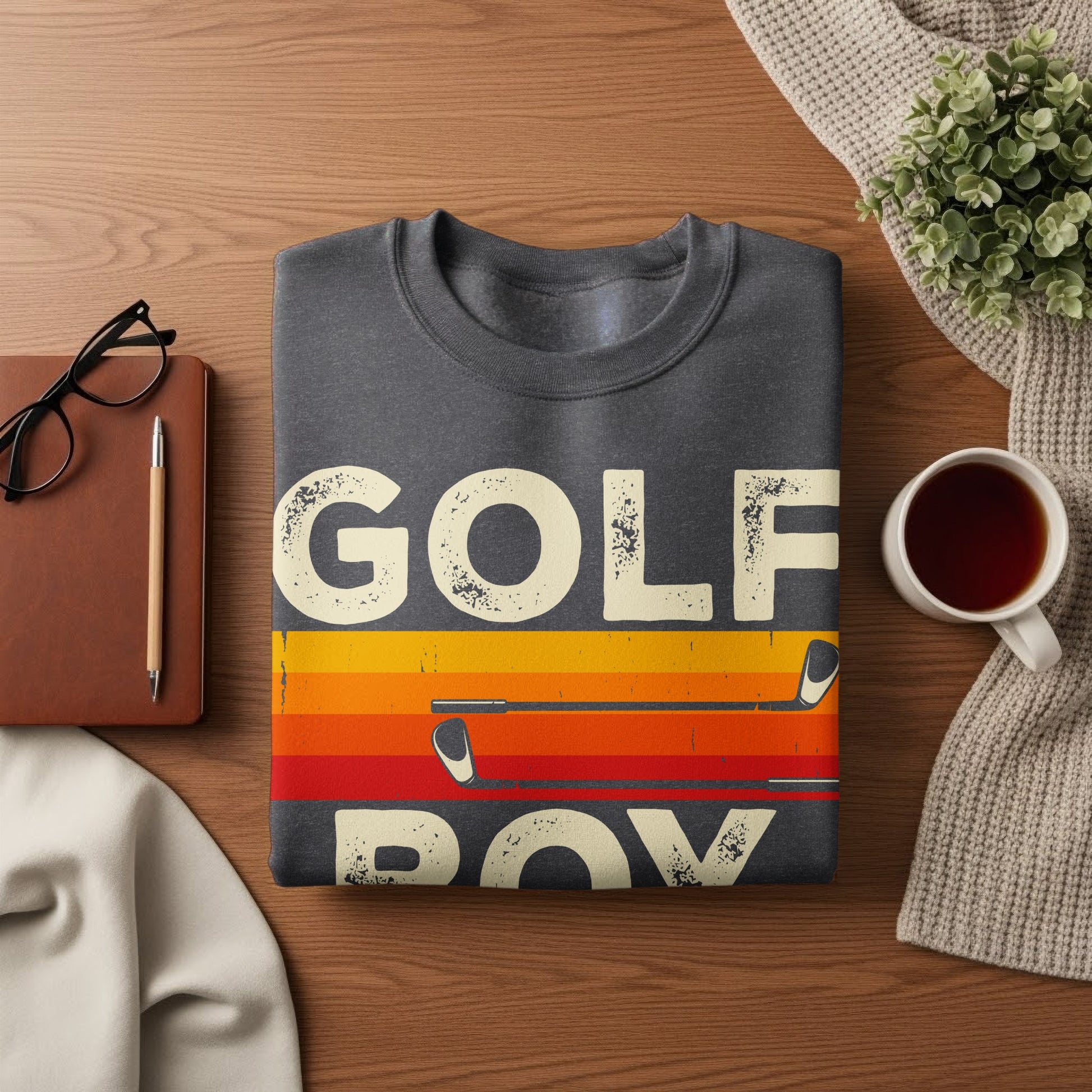 Dark gray sweatshirt with "GOLF" and "BOY" in bold, colorful striped text.