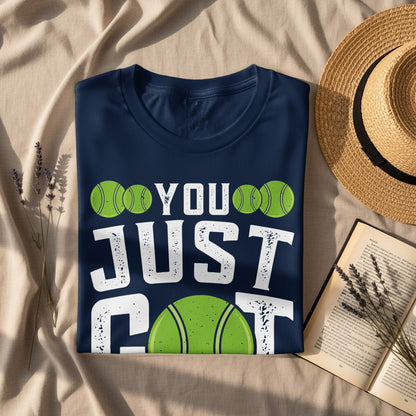 Navy t-shirt with "YOU JUST GOT" text and tennis ball graphics.