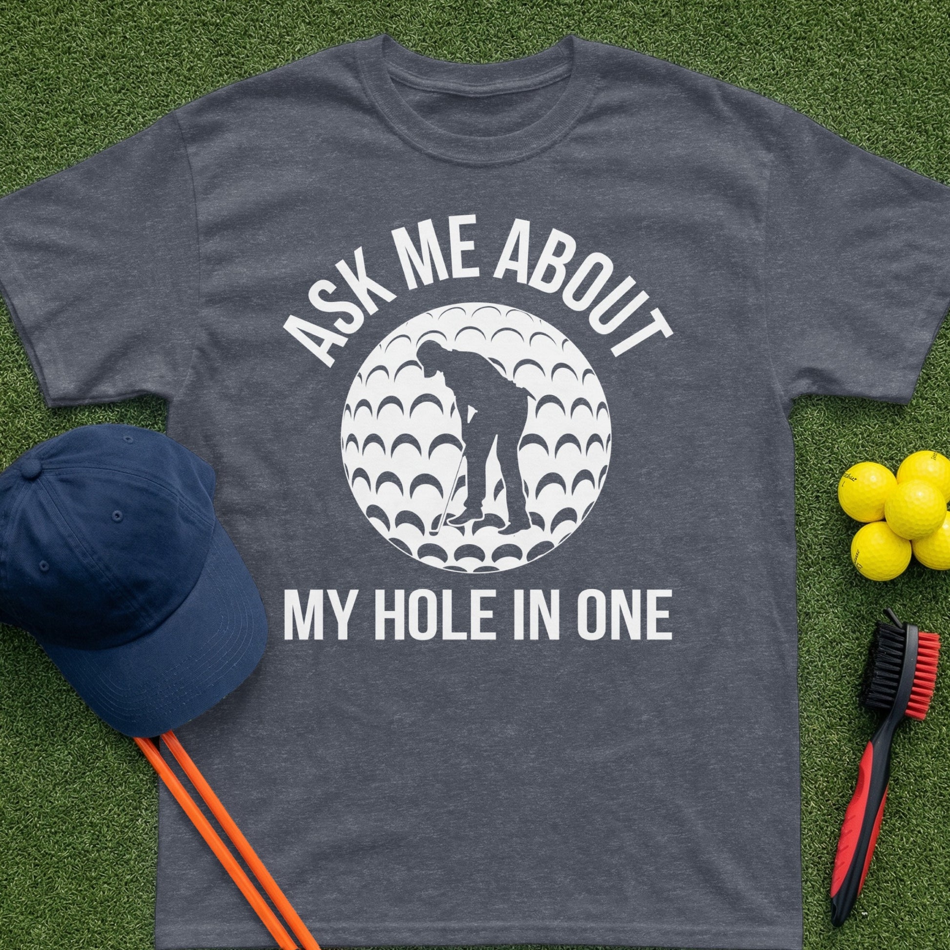Dark gray t-shirt with "Ask Me About My Hole In One" and golf ball graphic.