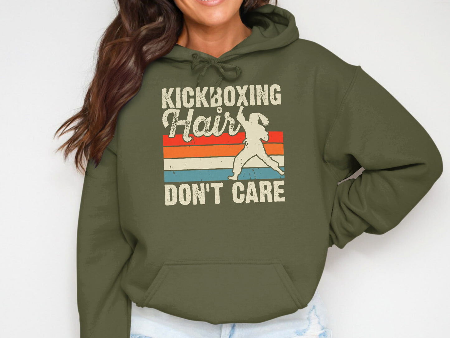Olive green hoodie with "Kickboxing Hair Don't Care" text and retro stripes.