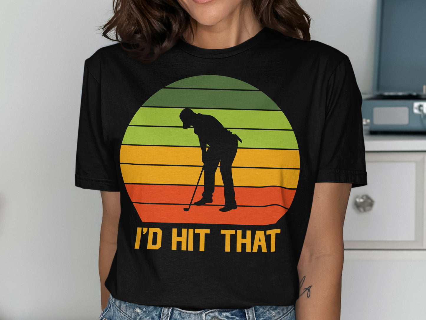 Golfer silhouetted against a sunset graphic, with "I'D HIT THAT" text.