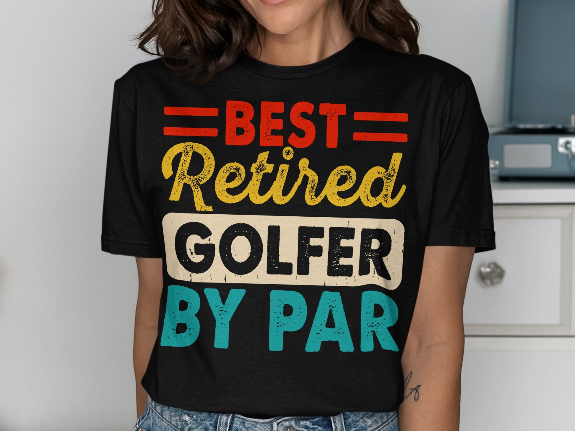 Black t-shirt with "BEST RETIRED GOLFER BY PAR" text in red, yellow, and blue.