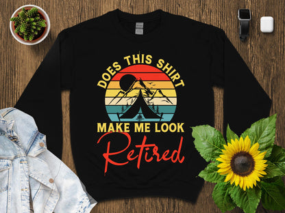 Black sweatshirt with "Does This Shirt Make Me Look Retired" text and mountain graphic.