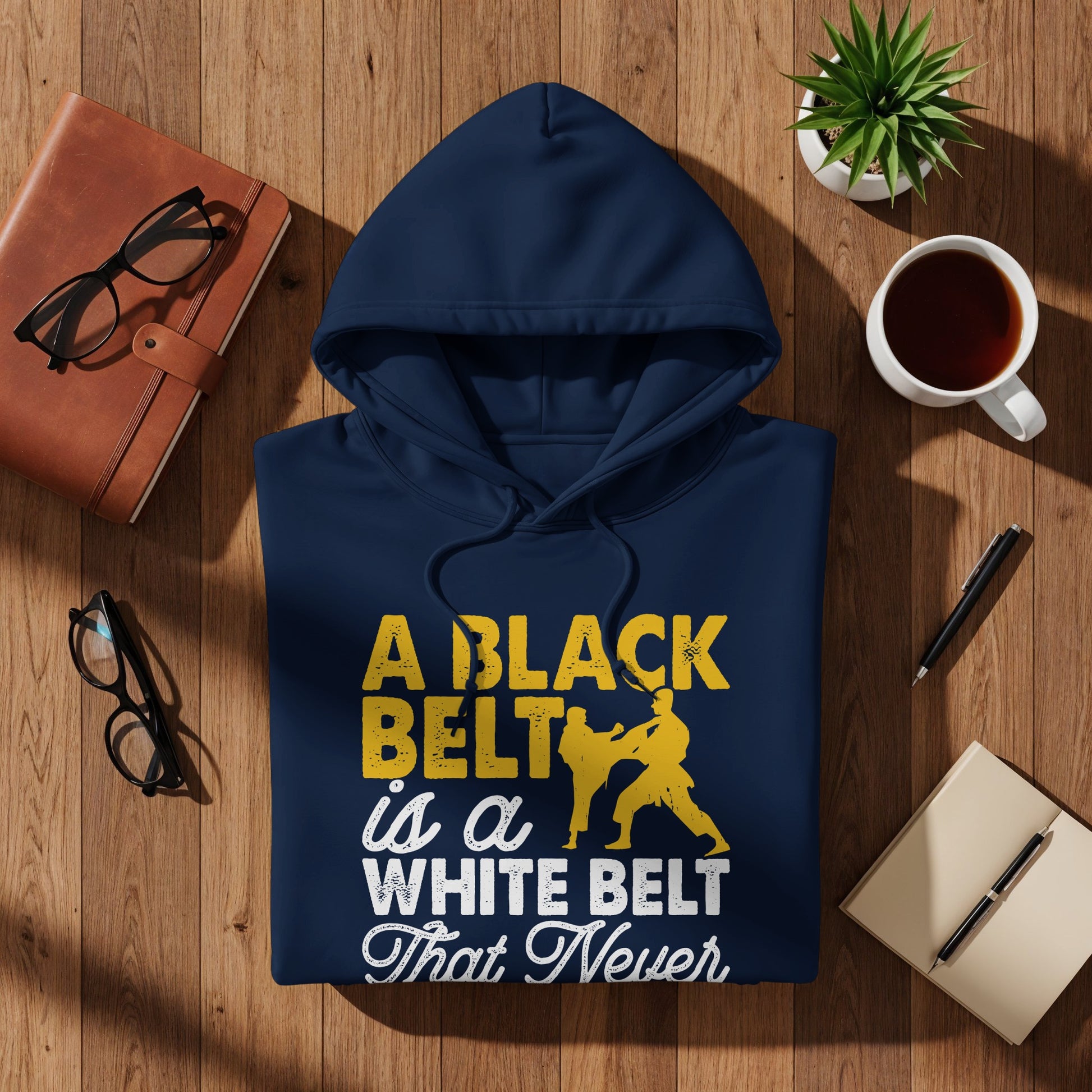 Navy hoodie with text "A BLACK BELT Is a WHITE BELT That Never" and martial arts graphic.
