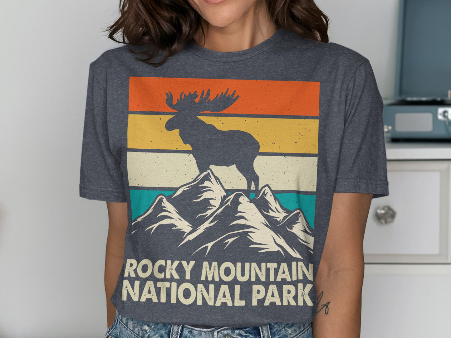 Moose on mountain peaks with Rocky Mountain National Park text.