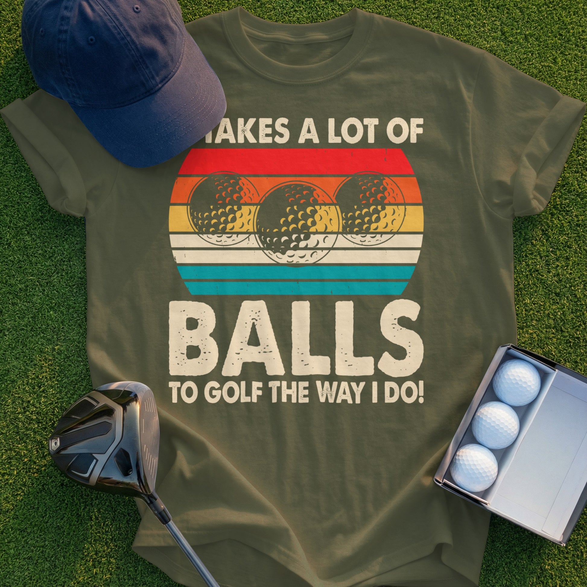 Olive t-shirt with golf balls and text that says "It takes a lot of balls to golf the way I do!"