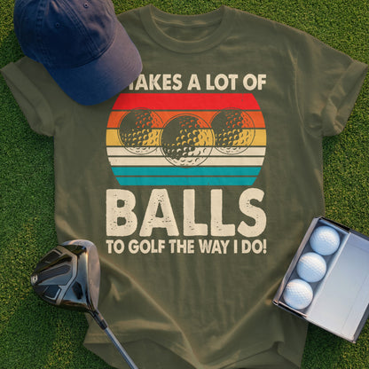 Olive t-shirt with golf balls and text that says "It takes a lot of balls to golf the way I do!"