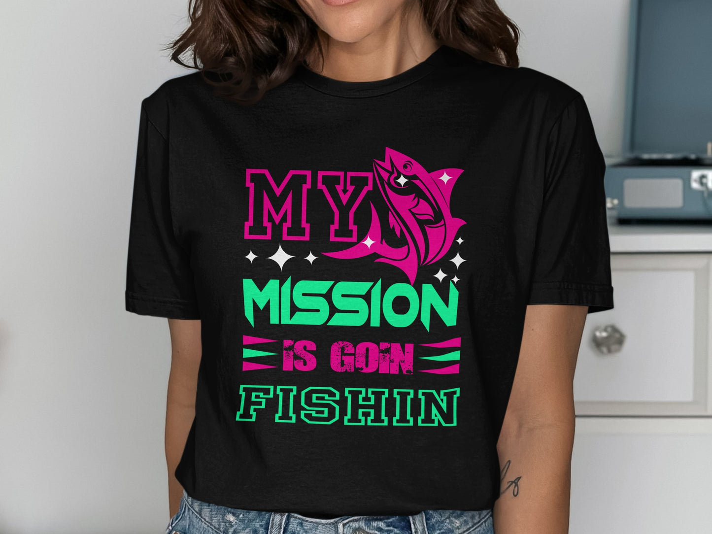 Black t-shirt with "MY MISSION IS GOIN FISHIN" text and a pink fish.