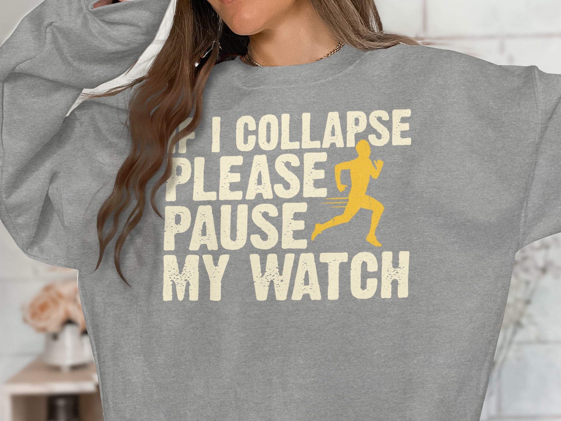 Grey sweatshirt with text "If I Collapse Please Pause My Watch" and a running figure.