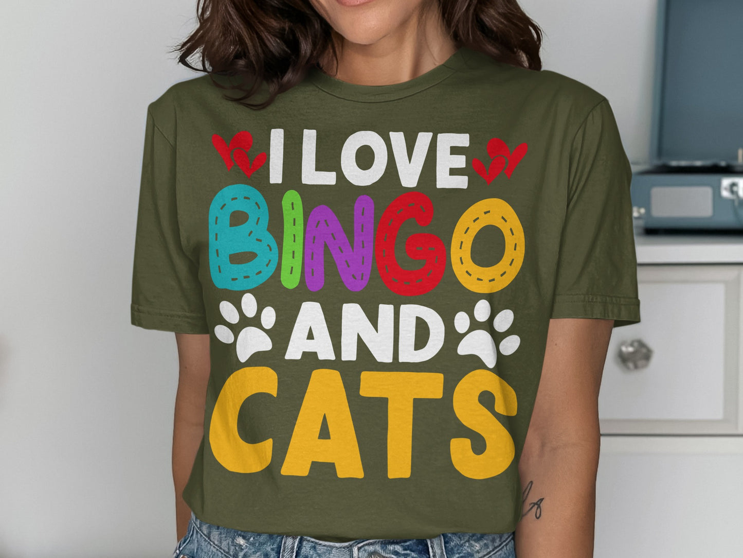 Green t-shirt with colorful "I LOVE BINGO AND CATS" text and paw prints.