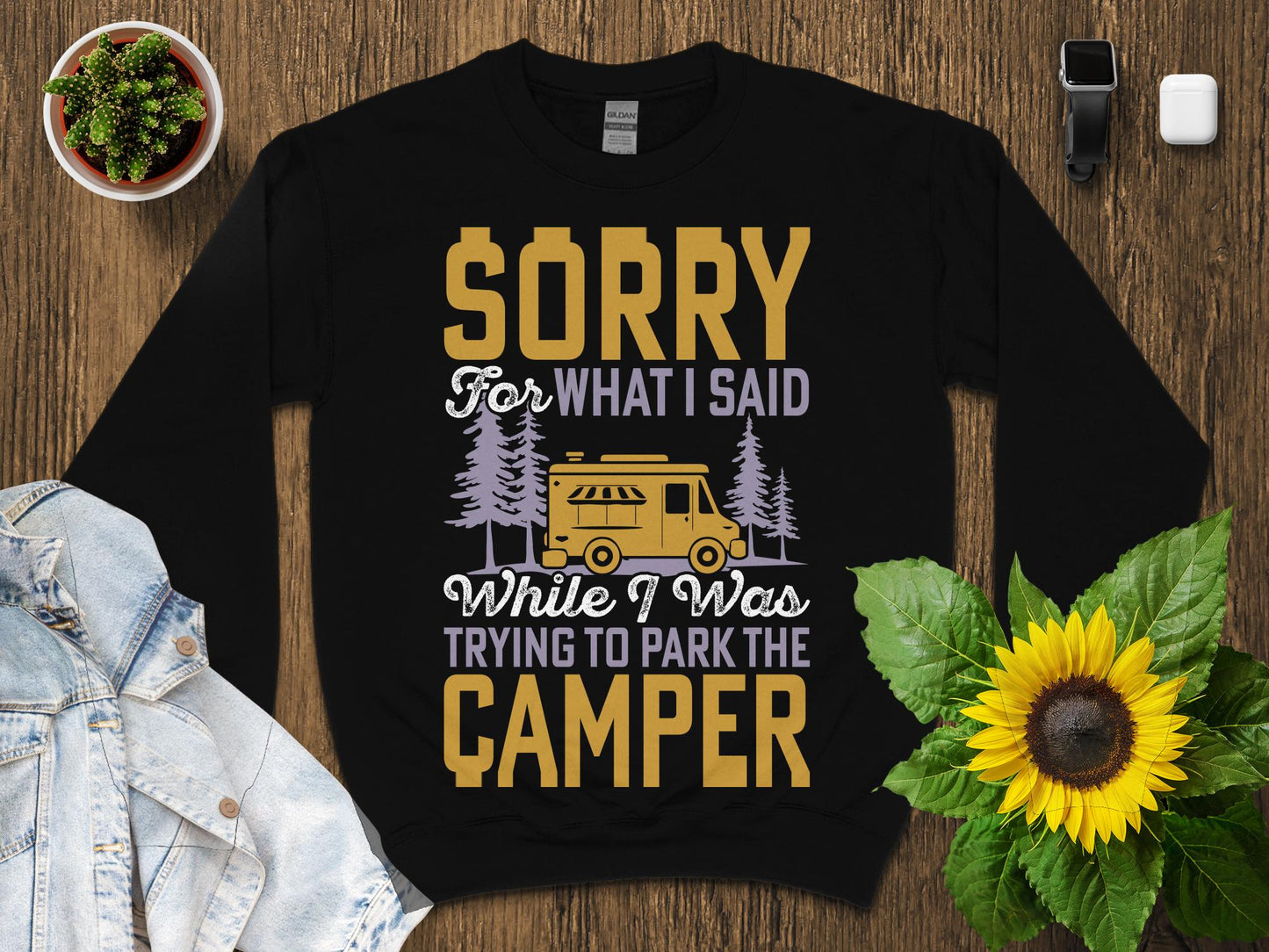Black sweatshirt with "Sorry For What I Said While I Was Trying to Park The Camper" text and graphic.