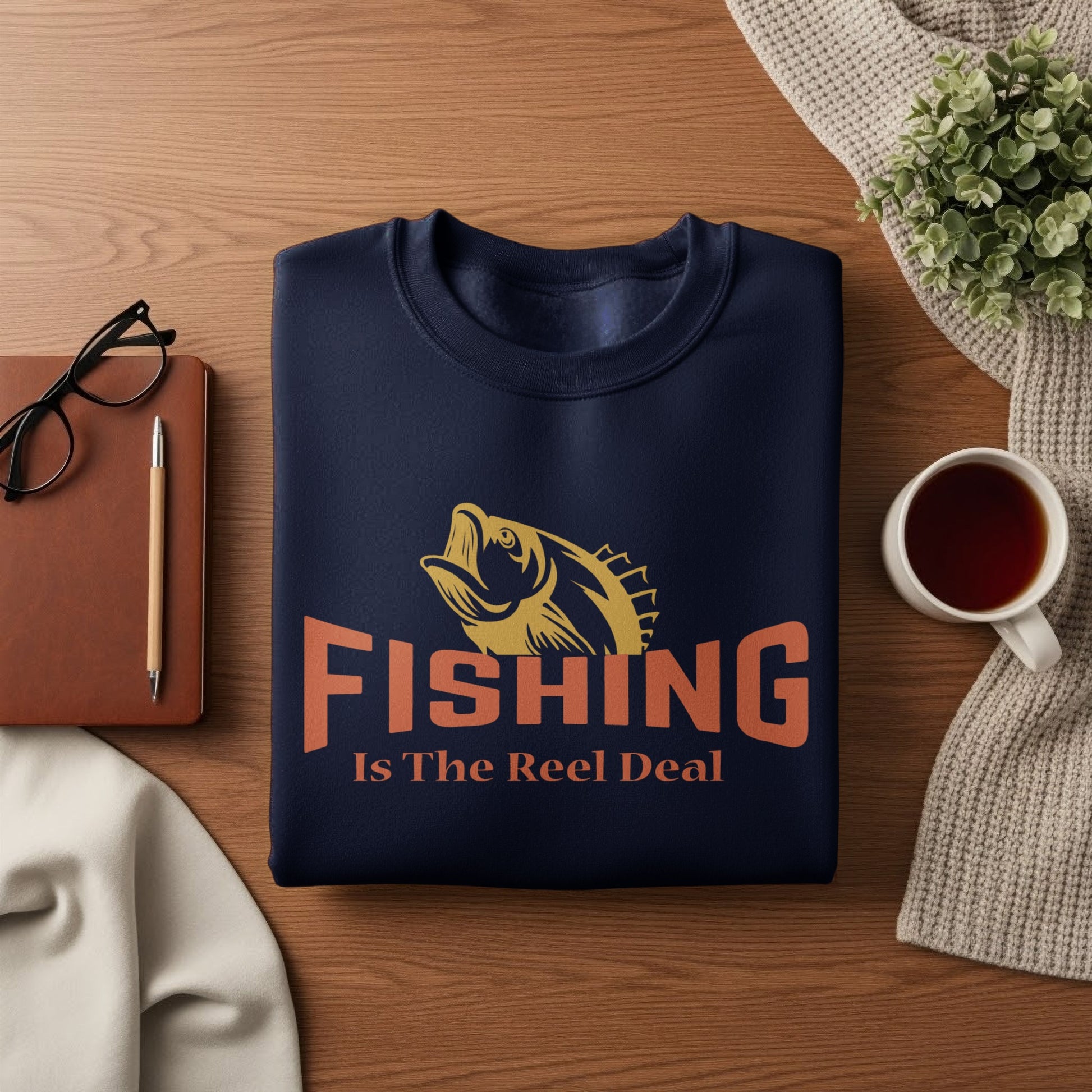 Dark blue sweatshirt with "Fishing Is The Reel Deal" text and fish graphic.