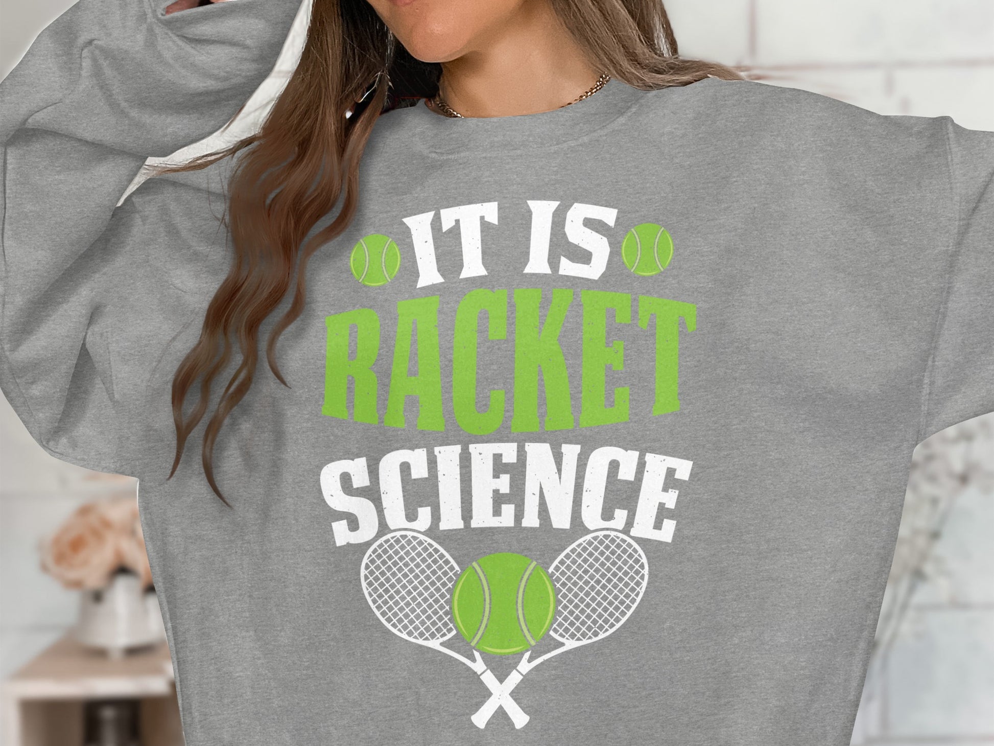 Gray sweatshirt with "IT IS RACKET SCIENCE" and tennis graphics.